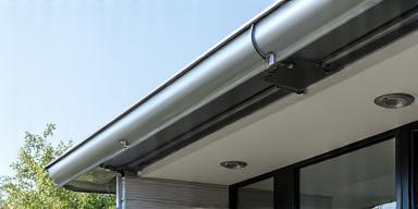 Newly installed seamless rain gutters on a commercial building.